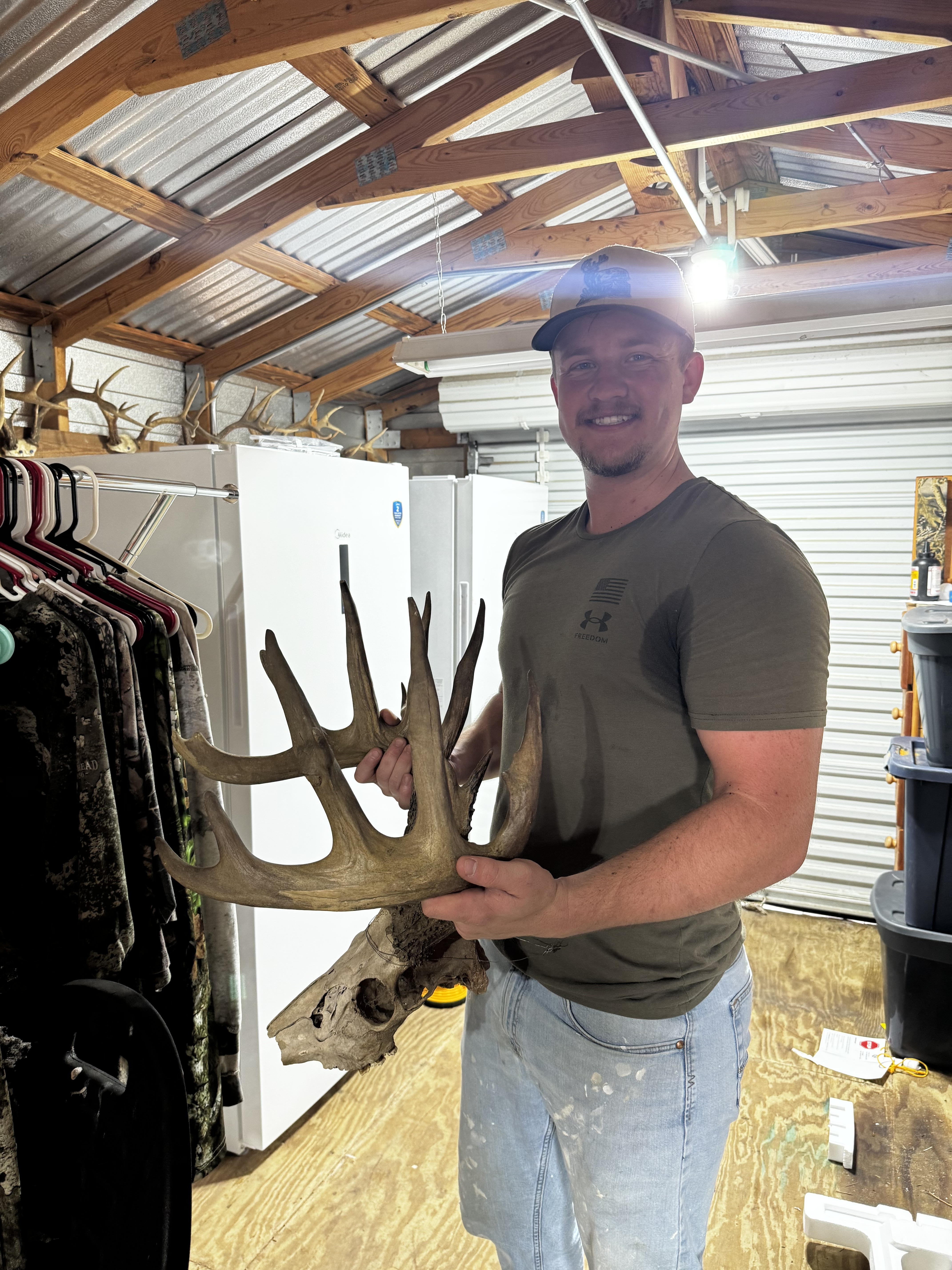 Truett holding a deer (owner photo)